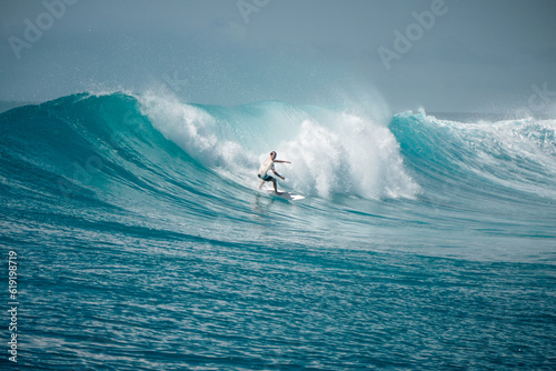 Fototapeta Naklejka Na Ścianę i Meble -  Surfer on perfect blue aquamarine wave, empty line up, perfect for surfing, clean water, Indian Ocean