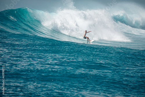 Surfer on perfect blue aquamarine wave, empty line up, perfect for surfing, clean water, Indian Ocean