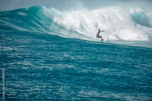 Surfer on perfect blue aquamarine wave, empty line up, perfect for surfing, clean water, Indian Ocean