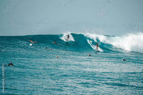 Two Surfer girls on long boards on perfect blue aquamarine wave together, party wave, empty line up, perfect for surfing, clean water, Indian Ocean, Maldives