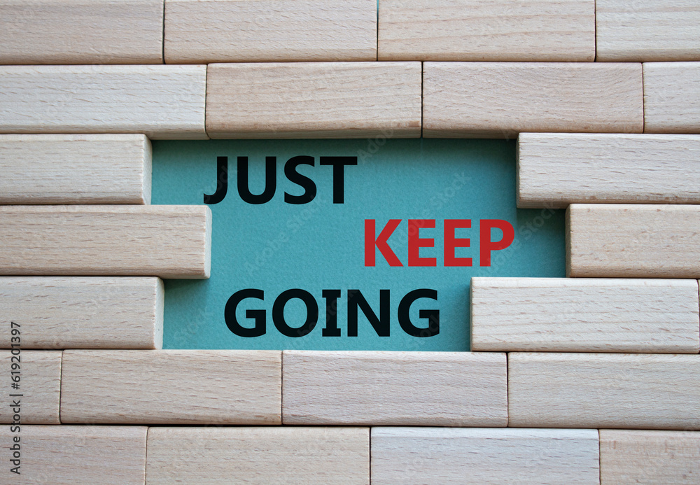 Just keep going symbol. Wooden blocks with words Just keep going. Beautiful grey green background. Business and Just keep going concept. Copy space. Just keep going symbol. Wooden blocks with words Just keep going. Beautiful grey green background. Business and Just keep going concept. Copy space.