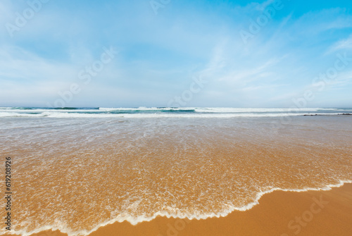 Summer sandy beach with surf wave (Algarve, Costa Vicentina, Portugal).