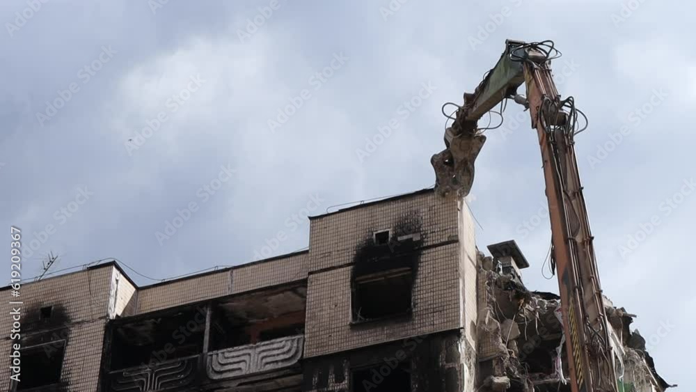 Building Scrape Excavator with hydraulic crusher at the demolition of a residential ...