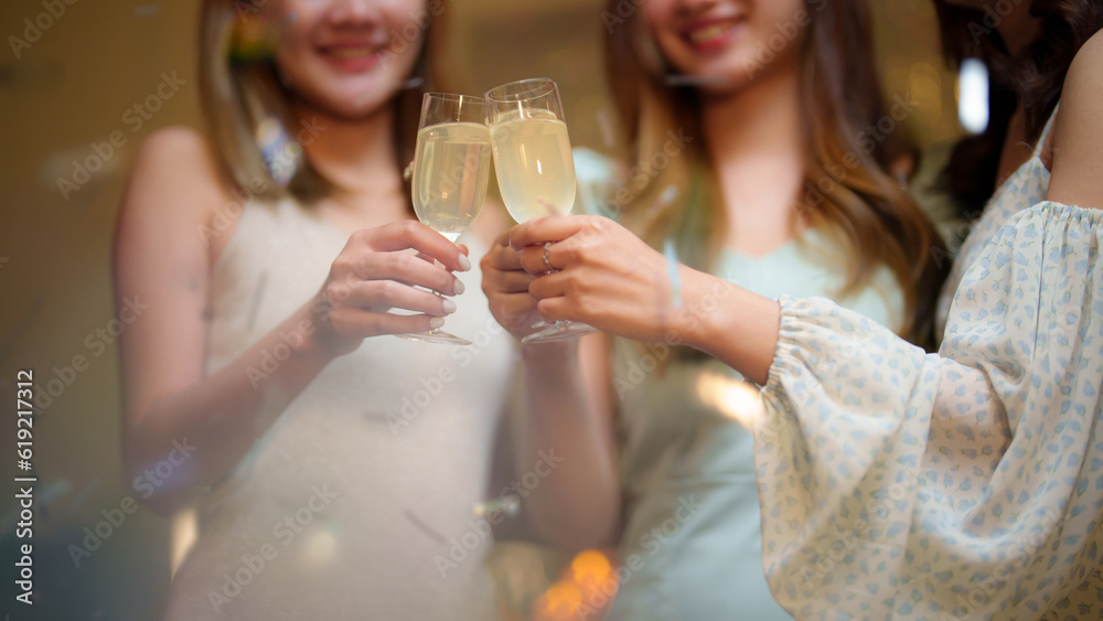 Group of friends celebrating with champagne  Close up on hands.