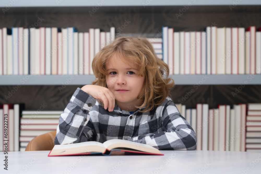 Child in the library reads books. Schoolkid choosing book in school library. Kids literature for reading. Kid in bookstore. Learning from books. School education. Back to school. Child in the library reads books. Schoolkid choosing book in school library. Kids literature for reading. Kid in bookstore. Learning from books. School education. Back to school.