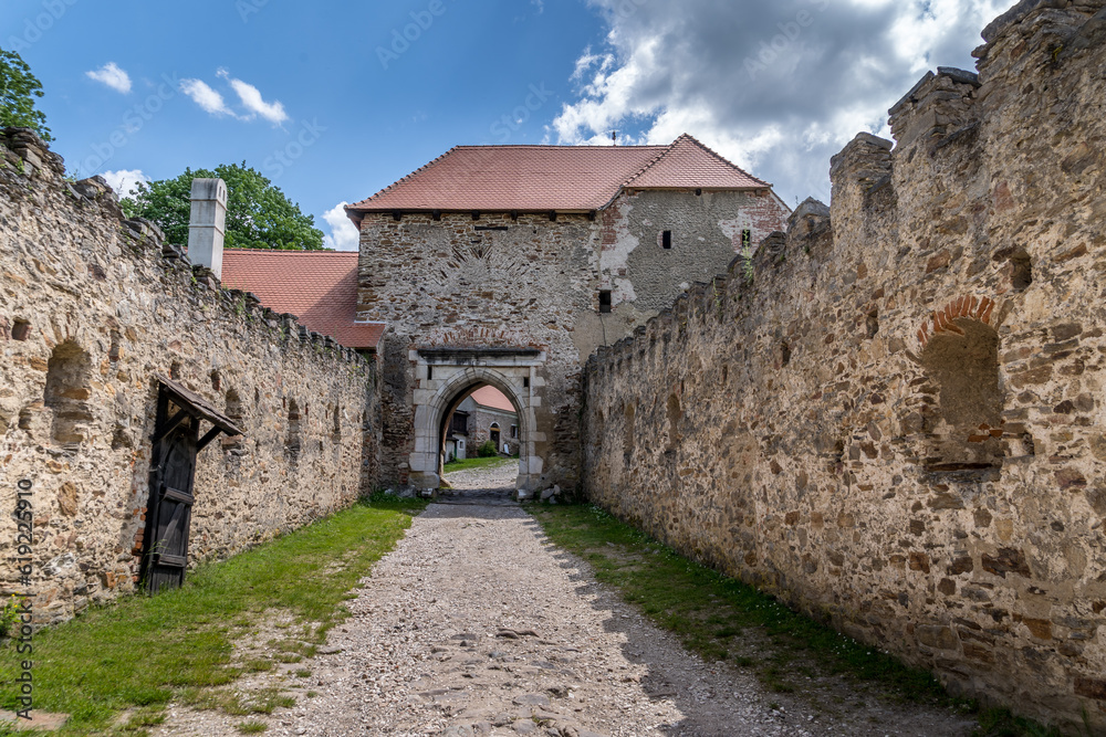 Obraz premium Zwinger with crenellated walls leading up to the medieval gate at Pernstejn castle