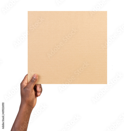Man holding a blank rectangular piece of brown cardboard isolated on white or transparent background © photka