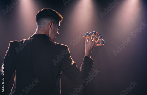 Man with balls between fingers