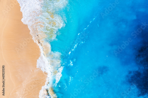 Coast as a background from top view. Waves and beach. Aerial landscape. Azure water background from drone. Summer seascape from air. Vacation time.