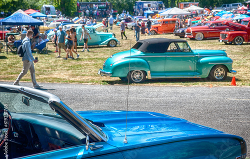 Large vintage car show in the summer.