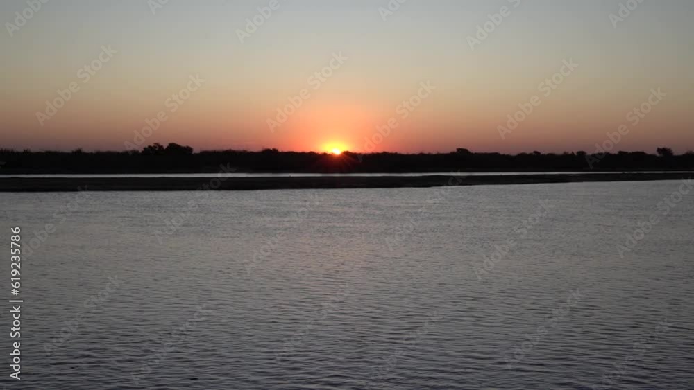 Panorama view of the river and sun hiding in the horizon. Panorama view of the river and sun hiding in the horizon.