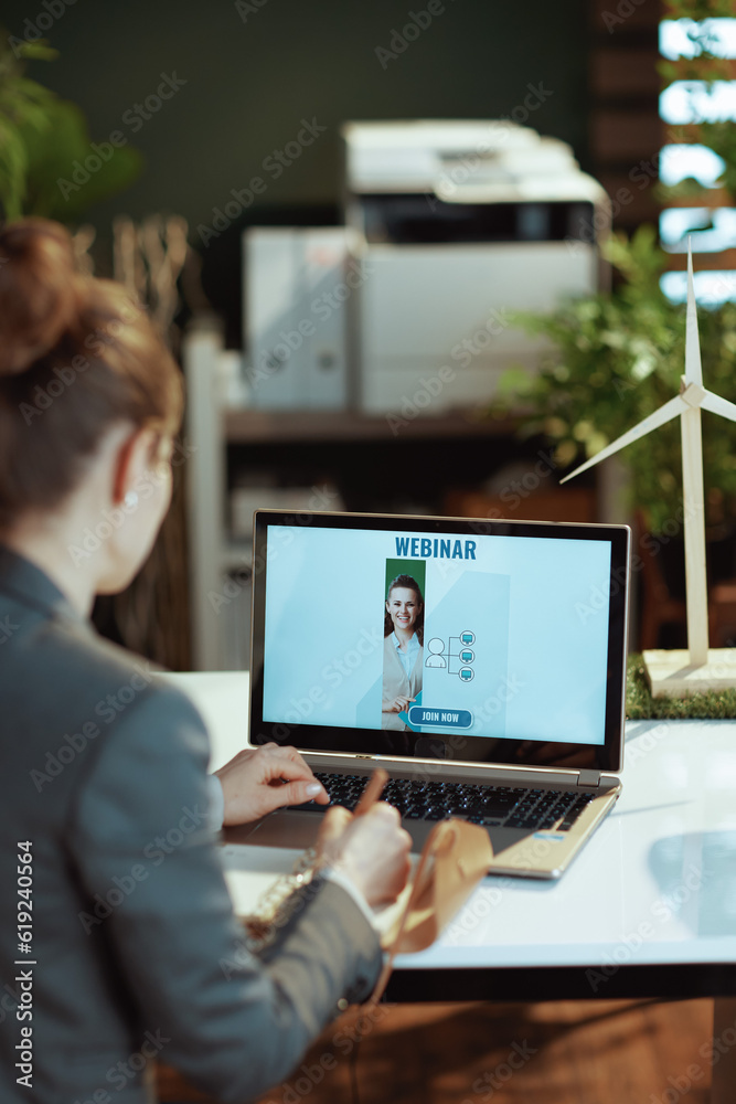 modern woman writes in notebook and having online webinar modern woman writes in notebook and having online webinar