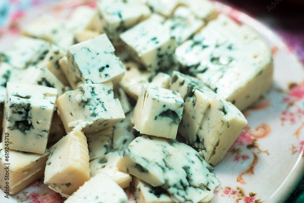 A soft cheese diced on a plate for picnic snacks or canapes This is the Camembert or Brie, family of cheeses A soft cheese diced on a plate for picnic snacks or canapes This is the Camembert or Brie, family of cheeses