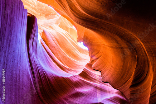 Abstract sandstone underground canyon cave with strong light and orange, red and purple color.