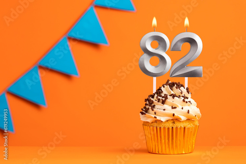 Candle number 82 - Cake birthday in orange background