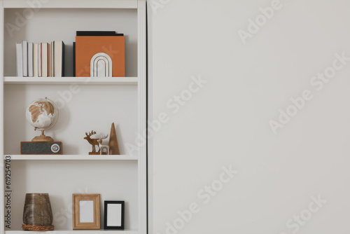 Stylish shelves with different decor elements indoors, space for text. Interior design