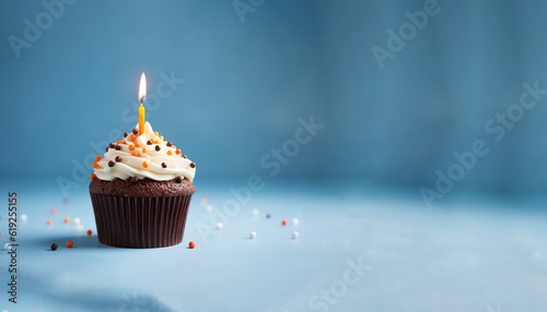 Happy birthday cupcake with a candle, chocolate birthday cake with sprinkles on blue background, negatice space for text, generative ai