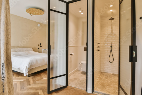 a bathroom with a bed in the corner and shower doors open to reveal a large walk - in shower area