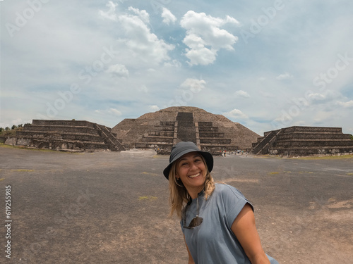 woman takes a selfie photo at the pyramid of the moon in Teotihuacan, Mexico City