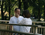 Portrait of a young couple on a bridge in the park.