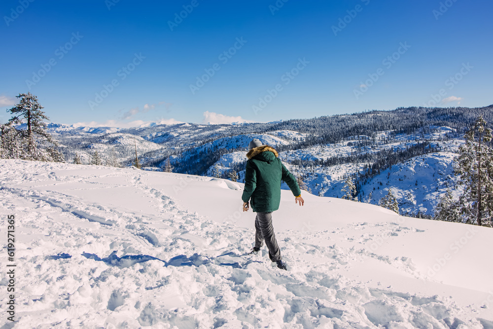 Man walking in the snow in the mountains