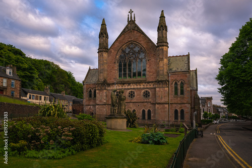 2023-06-02 THE NESS BANK CHURCH WITH A BEAUTIFUL STATUE AND LAWN IN FRONT AND A NICE CLOUDY SKY IN INVERNESS SCOTLAND