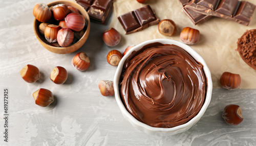Canvas Print Bowl with tasty chocolate paste and hazelnuts on table