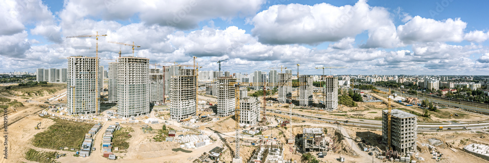 big construction site with apartment buildings under construction. panoramic aerial view in sunny summer day.