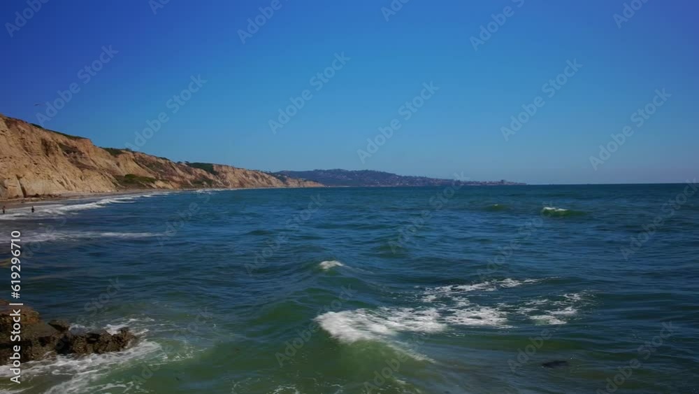 Panning right view of a beach in San Diego with a great view of the cliffs, rocks, and Pacific Ocean. Panning right view of a beach in San Diego with a great view of the cliffs, rocks, and Pacific Ocean.