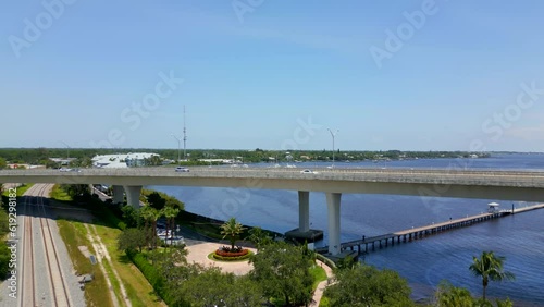 Aerial reveal marina with boat yacht Stuart Florida NW Federal Highway Roosevelt Bridge photo