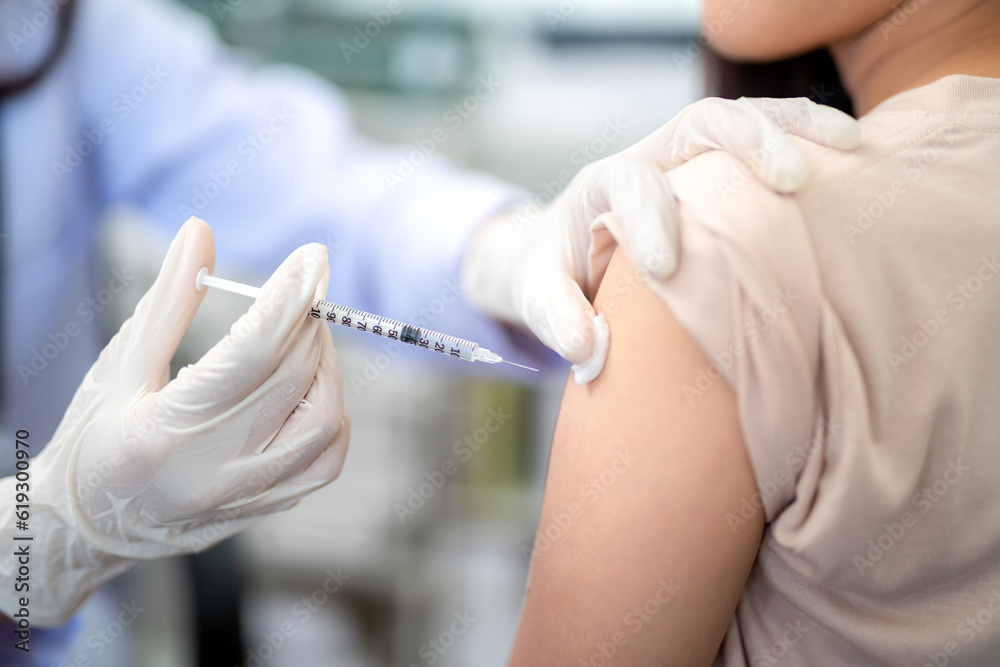 Close up of doctor making a vaccination in the shoulder of patient. coronavirus, Flu Vaccination Injection on Arm, covid-19 vaccine disease preparing for human clinical trials vaccination shot. Close up of doctor making a vaccination in the shoulder of patient. coronavirus, Flu Vaccination Injection on Arm, covid-19 vaccine disease preparing for human clinical trials vaccination shot.