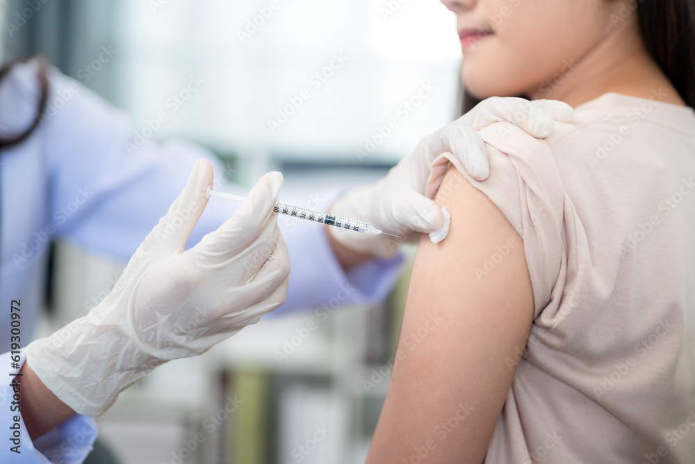 A doctor making a vaccination in the shoulder of patient. coronavirus, covid-19 vaccine disease preparing for human clinical trials vaccination shot. A doctor making a vaccination in the shoulder of patient. coronavirus, covid-19 vaccine disease preparing for human clinical trials vaccination shot.