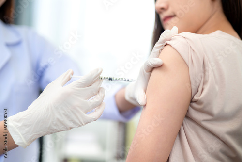 A doctor making a vaccination in the shoulder of patient, Flu Vaccination Injection on Arm.