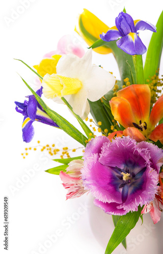 Bright spring bouquet in a white vase. spring flowers, daffodils, tulips, hyacinths, irises and mimosa isolated on a white background