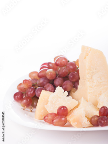 grapes and parmesan. Parmesan cheese and grapes isolated on a white backgroun. View from above