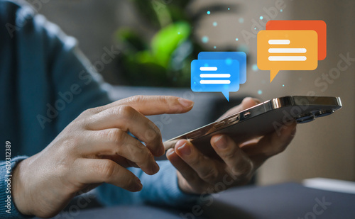 Human hand using smartphone typing Live chat chatting and social network concepts, chatting conversation working at home in chat box icons pop up. Social media marketing technology concept