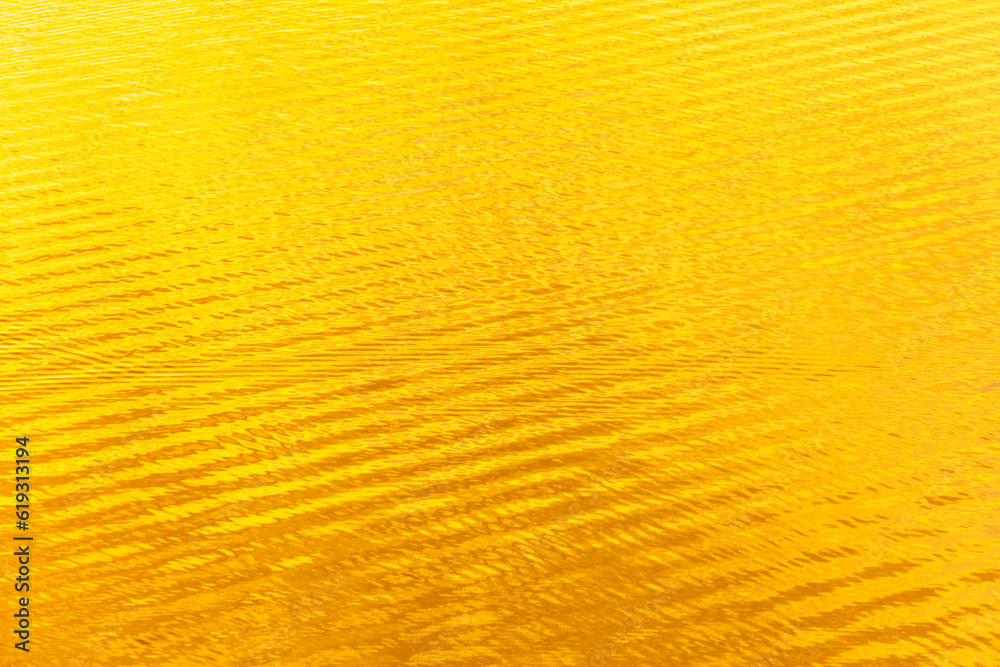 Water ripples in golden tones. Abstract background and texture for design Water ripples in golden tones. Abstract background and texture for design