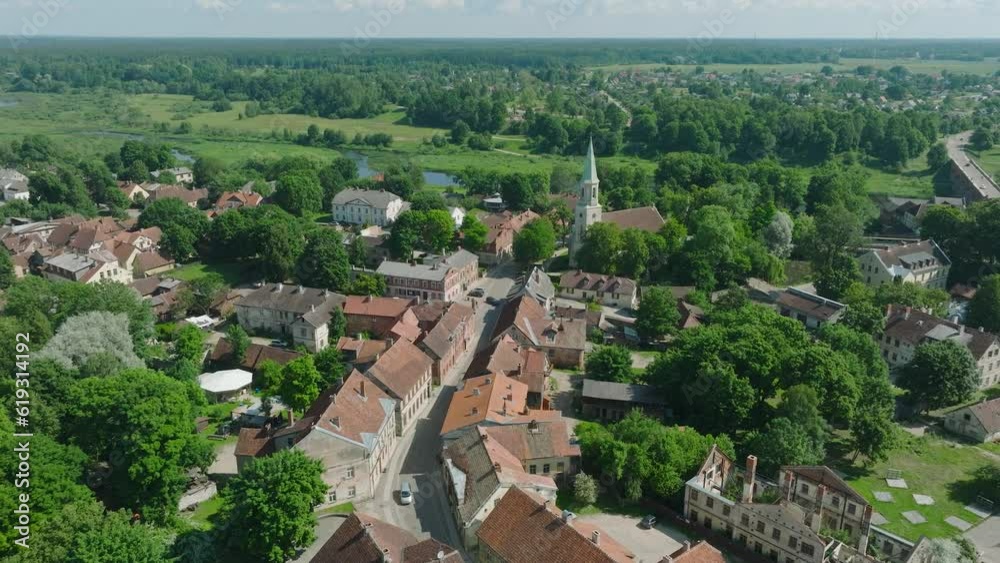 Aerial establishing view of Kuldiga Old Town (UNESCO heritage), houses with red roof tiles, sunny summer day, travel destination, wide drone shot moving forward, tilt down Aerial establishing view of Kuldiga Old Town (UNESCO heritage), houses with red roof tiles, sunny summer day, travel destination, wide drone shot moving forward, tilt down