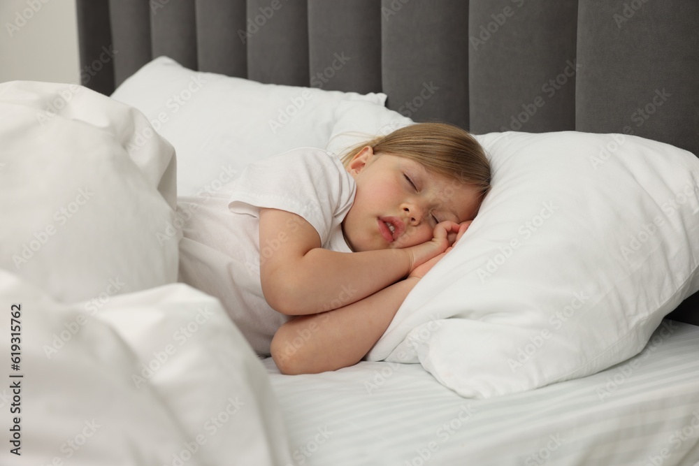 Little girl snoring while sleeping in bed
