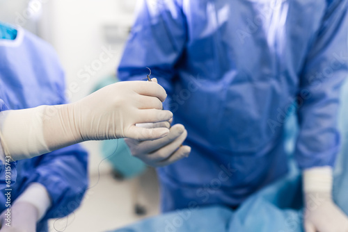 Shot in the Operating Room, Assistant Hands out Instruments to Surgeons During Operation. Surgeons Perform Operation. Professional Medical Doctors Performing Surgery.