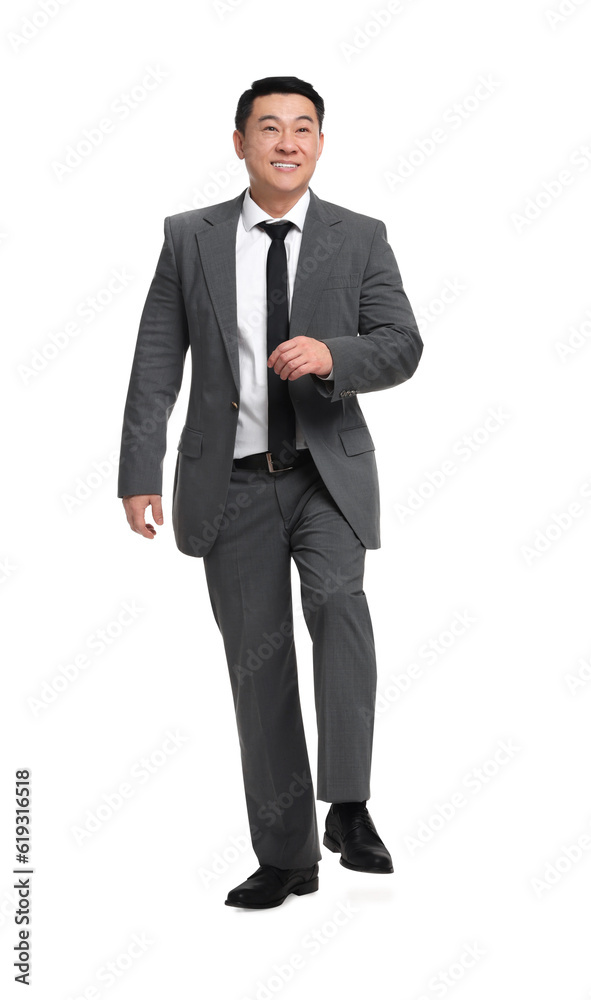 Businessman in suit walking on white background Businessman in suit walking on white background