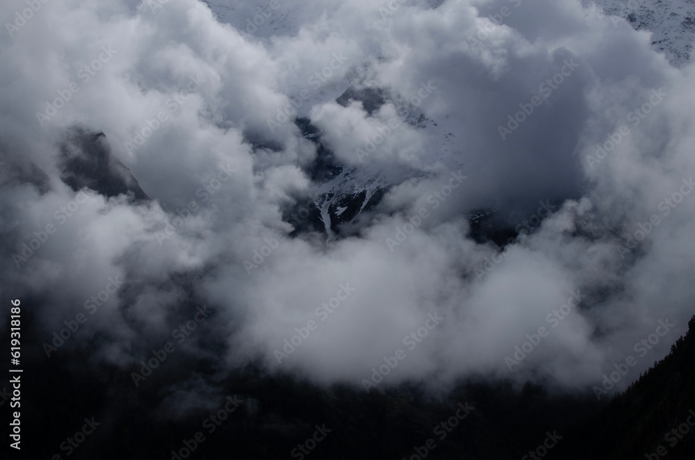 Picturesque view of high mountains covered with fog