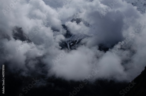 Picturesque view of high mountains covered with fog