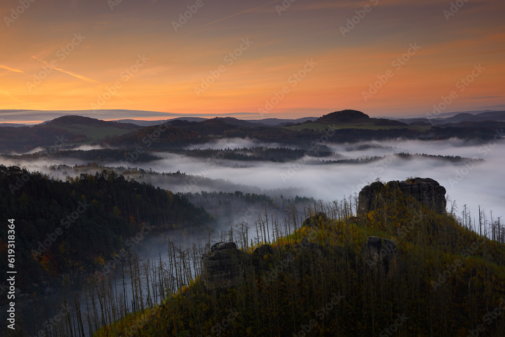 Misty morning. Czech typical autumn landscape. Hills and villages with foggy morning. Bohemian Switzerland park, Jetrichovice, Ceske Svycarsko.