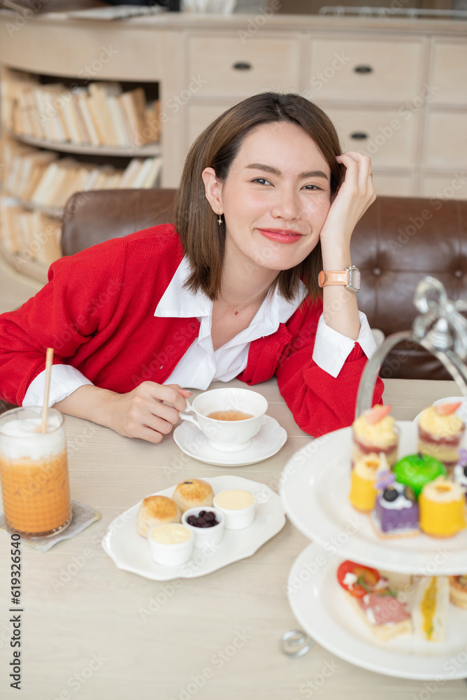 Beautiful woman on breakfast at outdoor cafe with amazing view. .woman pouring green herbal tea in glass cup. hot tea is in the glass cups. girl enjoy her hot coffee early in the morning. cake, bakery