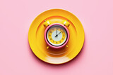Empty plate with alarm clock on pink, intermittent fasting concept, created with Generative AI technology.