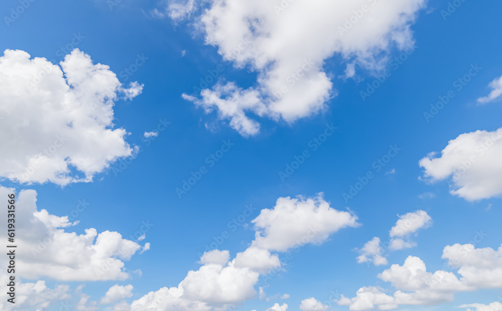 Panoramic view of clear blue sky and clouds, Blue sky background with tiny clouds. White fluffy clouds in the blue sky. Panoramic view of clear blue sky and clouds, Blue sky background with tiny clouds. White fluffy clouds in the blue sky.
