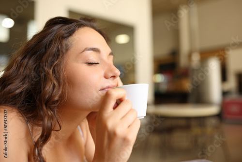 Woman enjoying coffee aroma in a restaurant