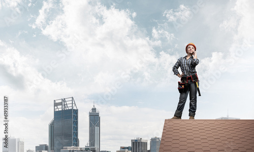 Attractive woman in workwear and hardhat