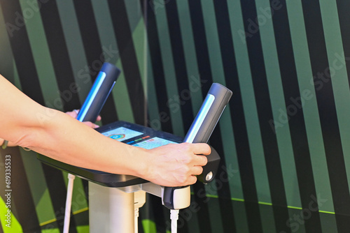 Woman hand touch the weight body composition for monitor her fat body analysis at gym fitness. Health fat lose monitor and checking in progress photo